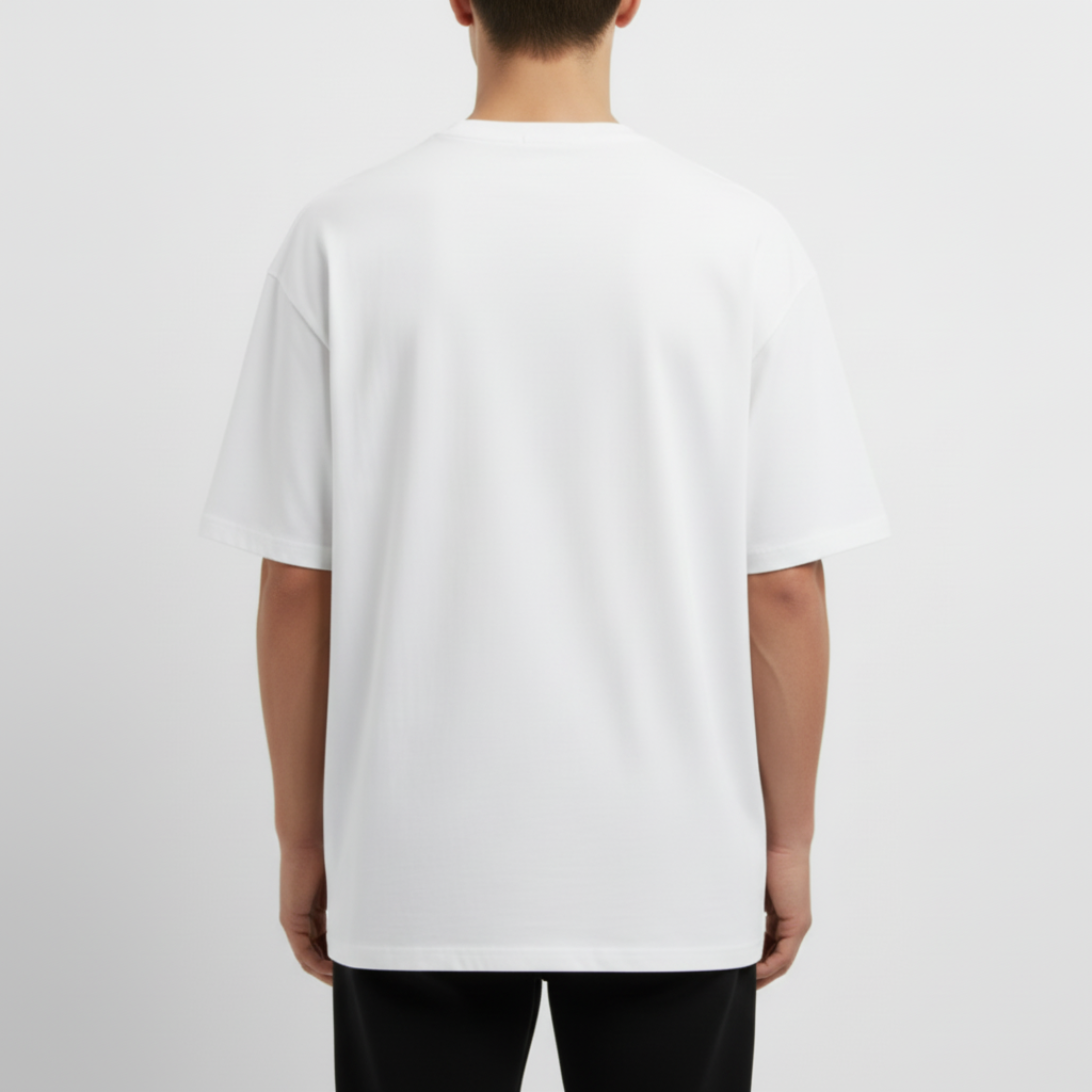 Person wearing a plain white t-shirt on a light gray background. Just Groom Me – Trimsalon Alphen aan den Rijn | Professional dog grooming & personalized pet apparel.